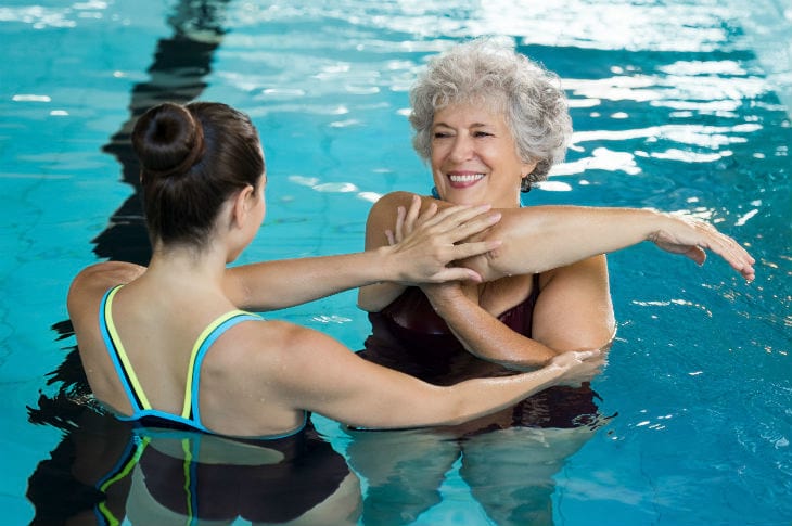 trainer helping senior w 158759054